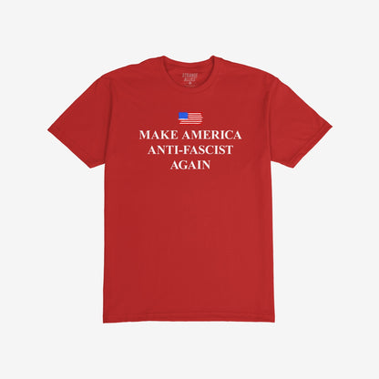 Red short-sleeve T-shirt featuring a stylized American flag and bold white text, MAKE AMERICA ANTI-FASCIST AGAIN, embodying a strong anti-fascist message by Strange Allies.