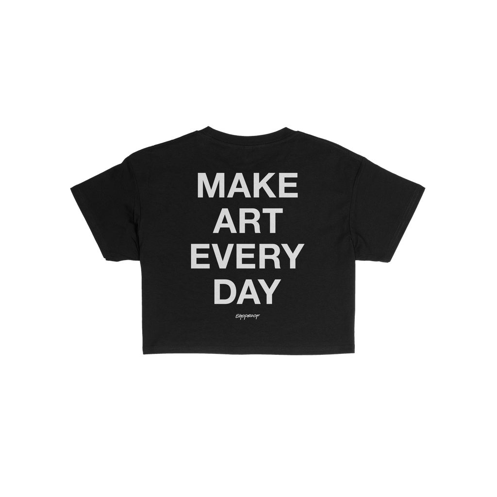 Back view of the Make Art Every Day Women's Baby Tee featuring bold white text, inspiring creativity. A small cursive brand m