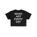 Back view of the Make Art Every Day Women's Baby Tee featuring bold white text, inspiring creativity. A small cursive brand m