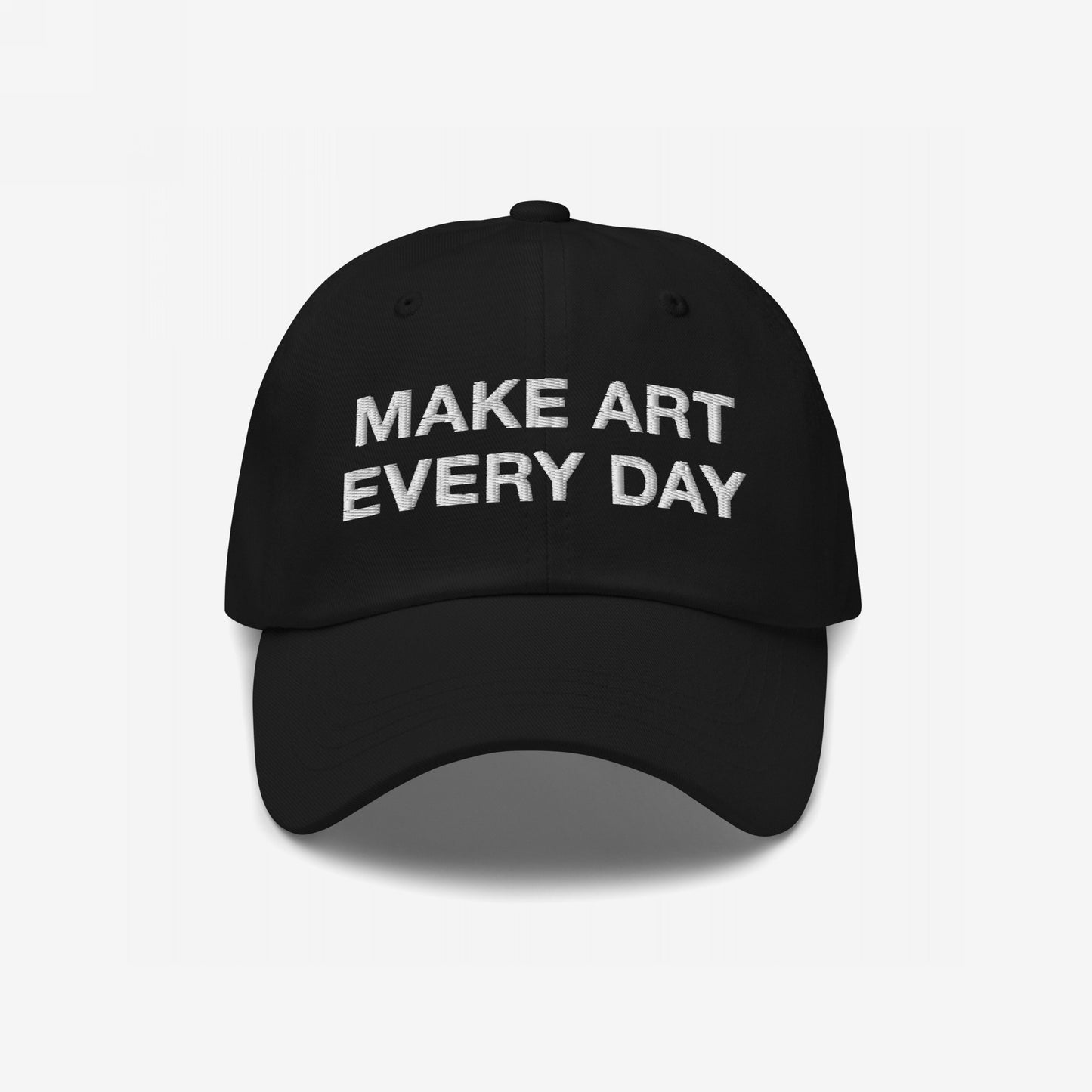 Black six-panel Make Art Every Day Hat with curved brim, showcasing white embroidery. Features adjustable closure for comfort, embodying a creative mantra. Perfect for artists and designers committed to daily creativity.
