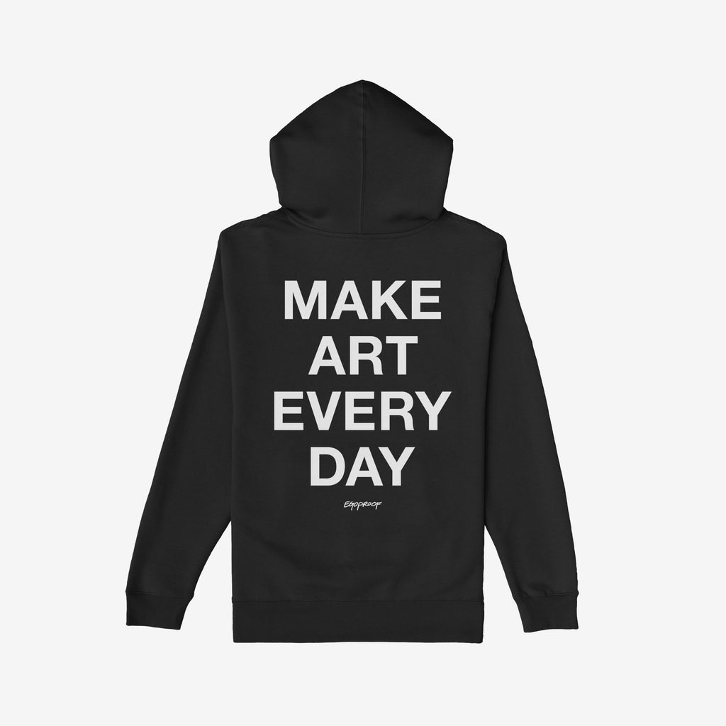 Make Art Every Day Hoodie featuring bold white block-letter text on the back, complemented by the small script brand name Egoproof. Laid flat, showcasing its creative and comfortable design ideal for artists.