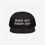 Black flat-brim snapback cap with “MAKE ART EVERY DAY” embroidered in bold white letters on the front. The back features EGOPROOF embroidery, adding a creative touch for committed artists and designers.