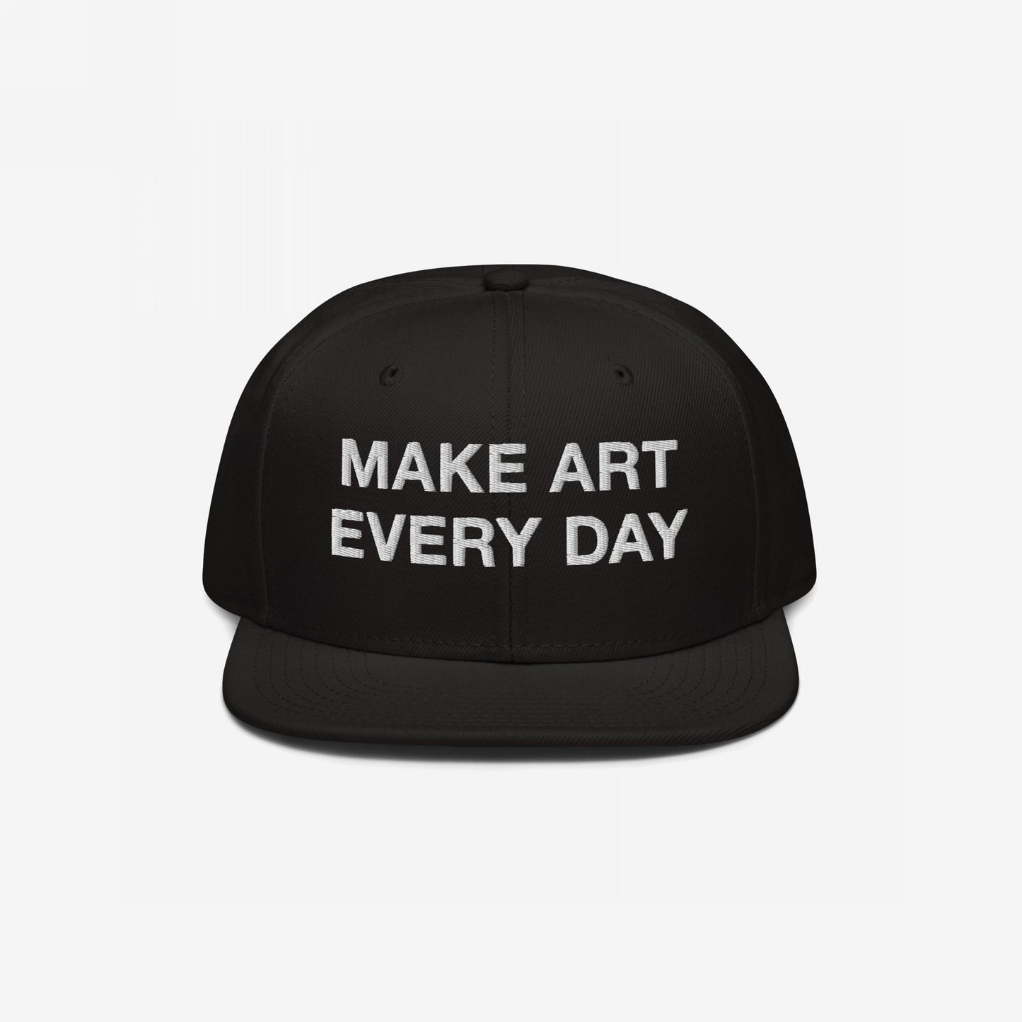 Black flat-brim snapback cap with “MAKE ART EVERY DAY” embroidered in bold white letters on the front. The back features EGOPROOF embroidery, adding a creative touch for committed artists and designers.