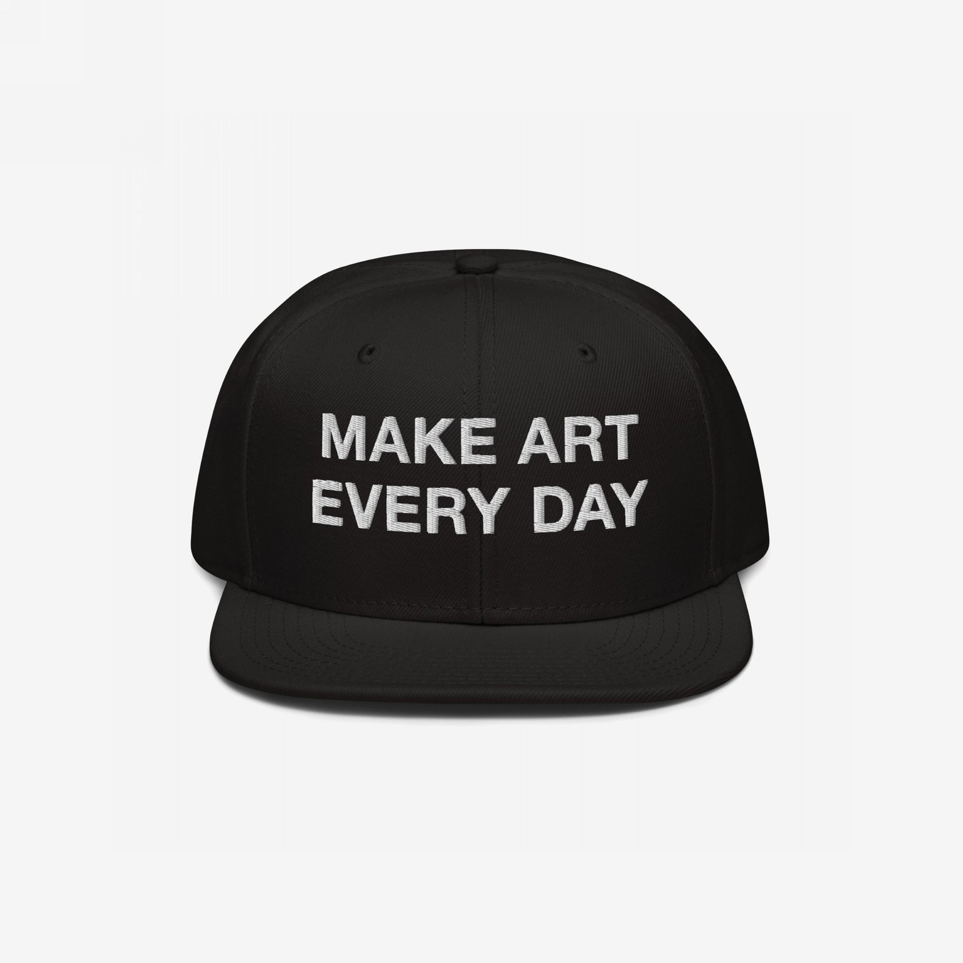 Black flat-brim snapback cap with “MAKE ART EVERY DAY” embroidered in bold white letters on the front. The back features EGOPROOF embroidery, adding a creative touch for committed artists and designers.