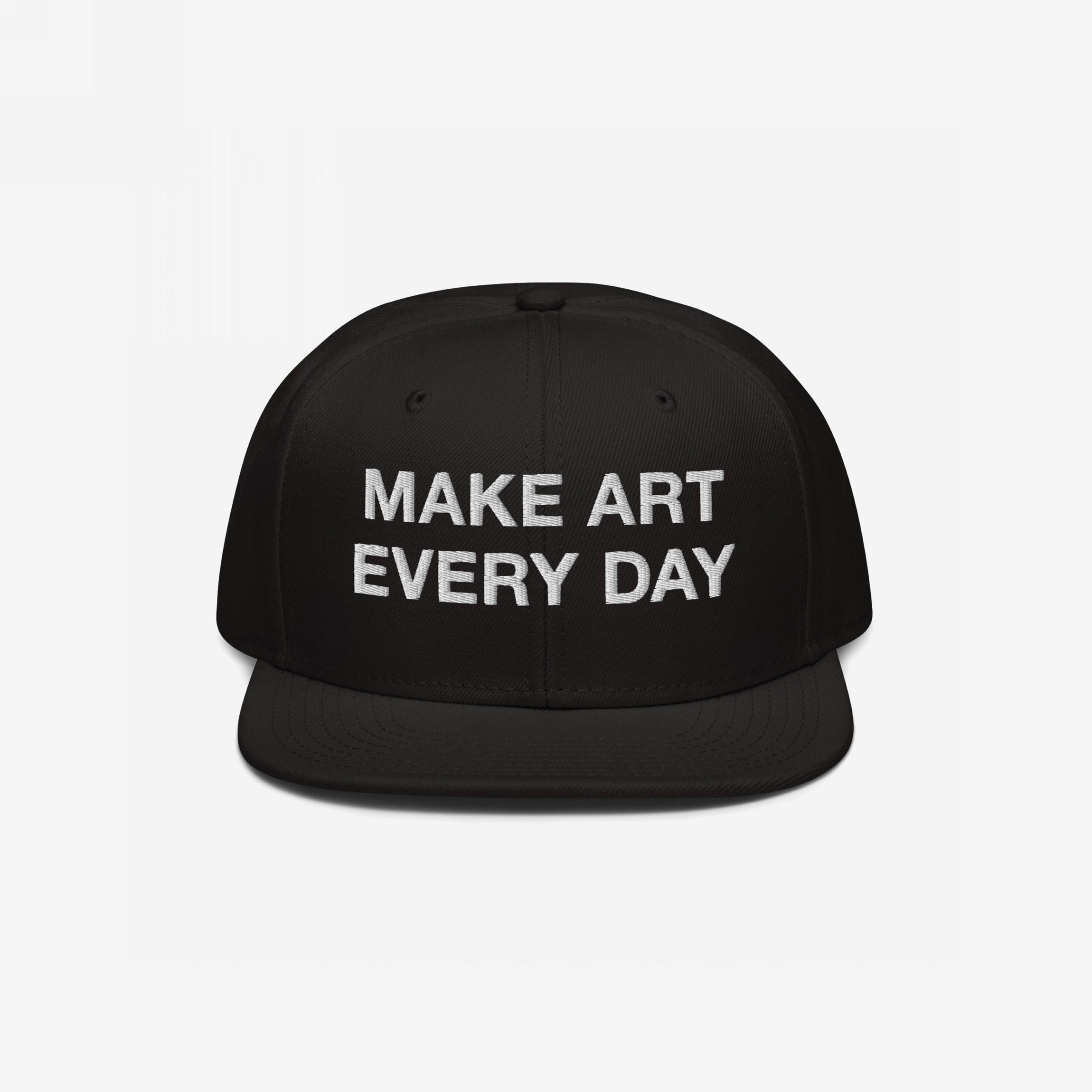 Black flat-brim snapback cap with “MAKE ART EVERY DAY” embroidered in bold white letters on the front. The back features EGOPROOF embroidery, adding a creative touch for committed artists and designers.