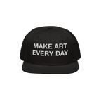 Black flat-brim snapback cap with “MAKE ART EVERY DAY” embroidered in bold white letters on the front. The back features 