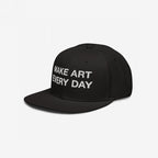 Make Art Every Day Hat: A black snapback cap with 'MAKE ART EVERY DAY' in bold white embroidery, designed for comfort and creativity, featuring EGOPROOF stitching on the back for committed creators.