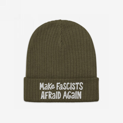 Olive-green rib-knit beanie with “Make Fascists Afraid Again” slogan embroidered in white on the cuff, reflecting an unapologetic stance against oppression.