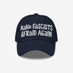 Make Fascists Afraid Again hat features bold white embroidery on a dark-navy cap, embodying defiance with raw, hand-drawn style, perfect for protests or daily wear with a statement.