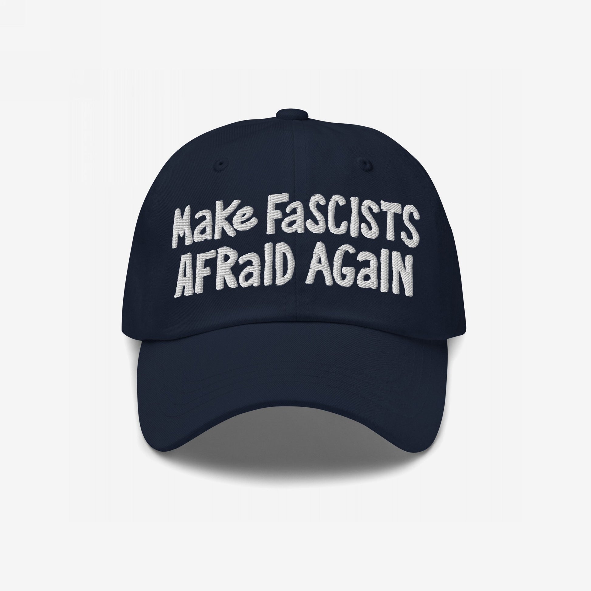 Make Fascists Afraid Again Hat with bold, white embroidered text on a dark navy-blue cap, embodying unapologetic resistance and activism. Available in multiple styles, supporting Amnesty International.