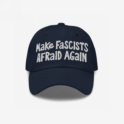 Make Fascists Afraid Again Hat with bold, white embroidered text on a dark navy-blue cap, embodying unapologetic resistance and activism. Available in multiple styles, supporting Amnesty International.