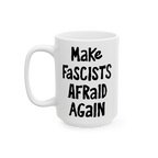 White ceramic mug with black, hand-drawn lettering: “Make Fascists Afraid Again”. Bold message supports resistance, ideal