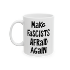 White ceramic mug with the slogan Make Fascists Afraid Again in bold black lettering. Features a standard C-handle, shiny fin