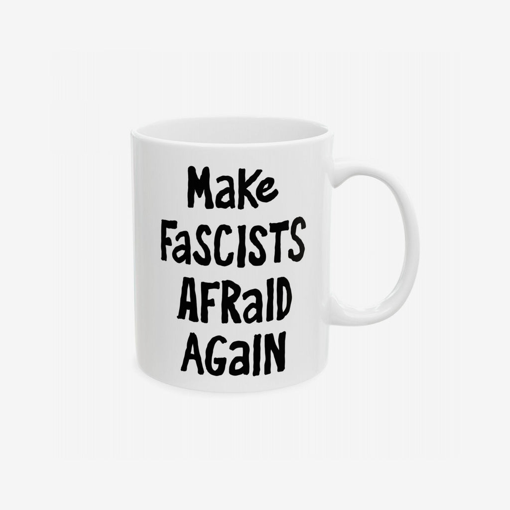 White ceramic Make Fascists Afraid Again mug with bold black lettering, designed to challenge authoritarianism. Features standard C-handle, shiny finish, printed on both sides. Available in 11 oz. and 15 oz.
