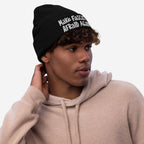 Young man in a light-tan hoodie wears the Make Fascists Afraid Again Hat, a black beanie with white embroidered slogan, embodying everyday resistance and defiance against fascism.