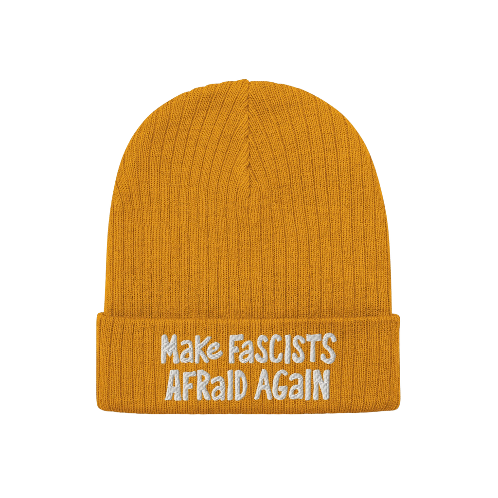 The Make Fascists Afraid Again Hat features a mustard-yellow knit with white embroidered slogan on its cuff, embodying defian