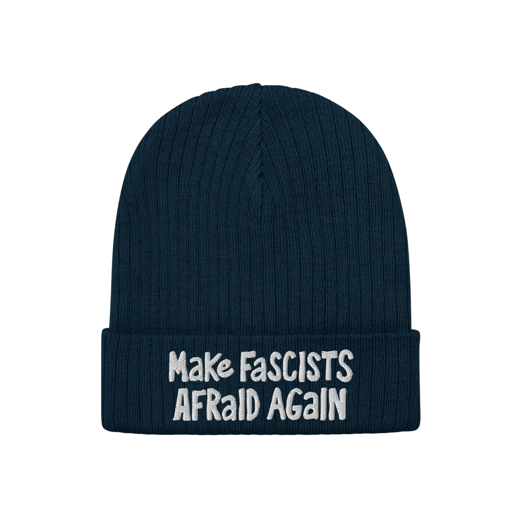 The Make Fascists Afraid Again hat features a navy knitted beanie with a folded cuff and bold white embroidered slogan, embod
