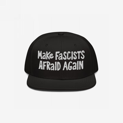 Black snap-back baseball cap with white embroidered text “Make Fascists Afraid Again,” capturing a bold stance against fascism. The cap embodies unapologetic resistance with its raw, hand-drawn lettering style.