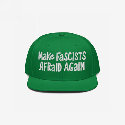 Green snap-back cap with bold white text reading Make Fascists Afraid Again, reflecting unapologetic resistance. Perfect for activism or everyday wear, supporting Amnesty International.