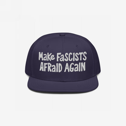 Dark-navy snapback cap with the slogan Make Fascists Afraid Again in white embroidery, embodying unapologetic resistance with bold, hand-drawn lettering. Ideal for activism or casual wear.