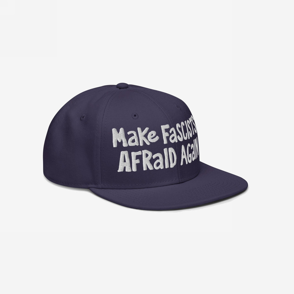 Make Fascists Afraid Again Hat features a navy-blue flat-brim design with raw, hand-drawn white embroidery. It's a bold statement piece for everyday resistance, benefiting the ACLU.
