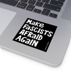 A silver laptop displays the Make Fascists Afraid Again sticker, featuring bold, hand-drawn lettering, symbolizing defiance against authoritarianism. Ideal for laptops, bumpers, or protest signs.
