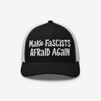 Black-and-white trucker-style baseball cap featuring bold white embroidery with the slogan “Make Fascists Afraid Again,” embodying resistance and activism, perfect for everyday wear or protests. Proceeds support the ACLU.