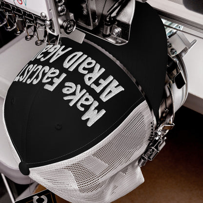 Make Fascists Afraid Again Hat in embroidery machine, white thread stitching bold text on black‐and‐white mesh trucker cap, embodying unapologetic resistance with a hand-drawn feel, ideal for active protest or daily defiance.
