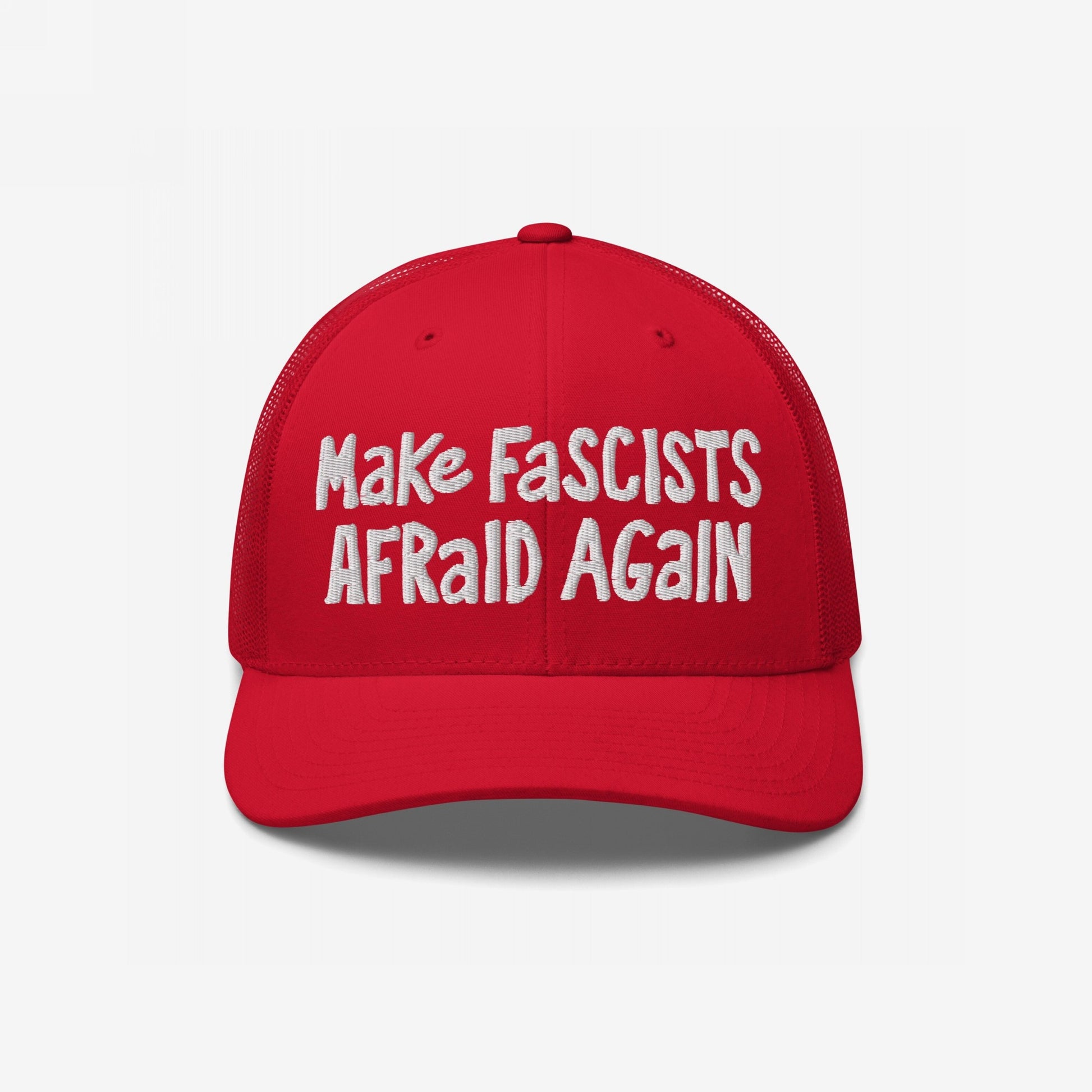 Red trucker-style Make Fascists Afraid Again hat with bold, messy white embroidery, echoing a familiar design, symbolizing unapologetic resistance.