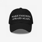Black cap featuring bold white embroidery, MAKE FASCISTS AFRAID AGAIN, embodies the Make Fascists Afraid Again Classic Hat's defiant stance, perfect for activists confronting hate.