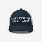 The Make Fascists Afraid Again Classic Hat features a navy-blue and white mesh-back with bold white embroidery, perfect for showcasing your anti-fascist stance and commitment to equality.
