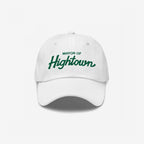 White six-panel baseball cap with MAYOR OF Hightown embroidered on the front in green, reflecting a playful, carefree vibe, ideal for cannabis culture enthusiasts.