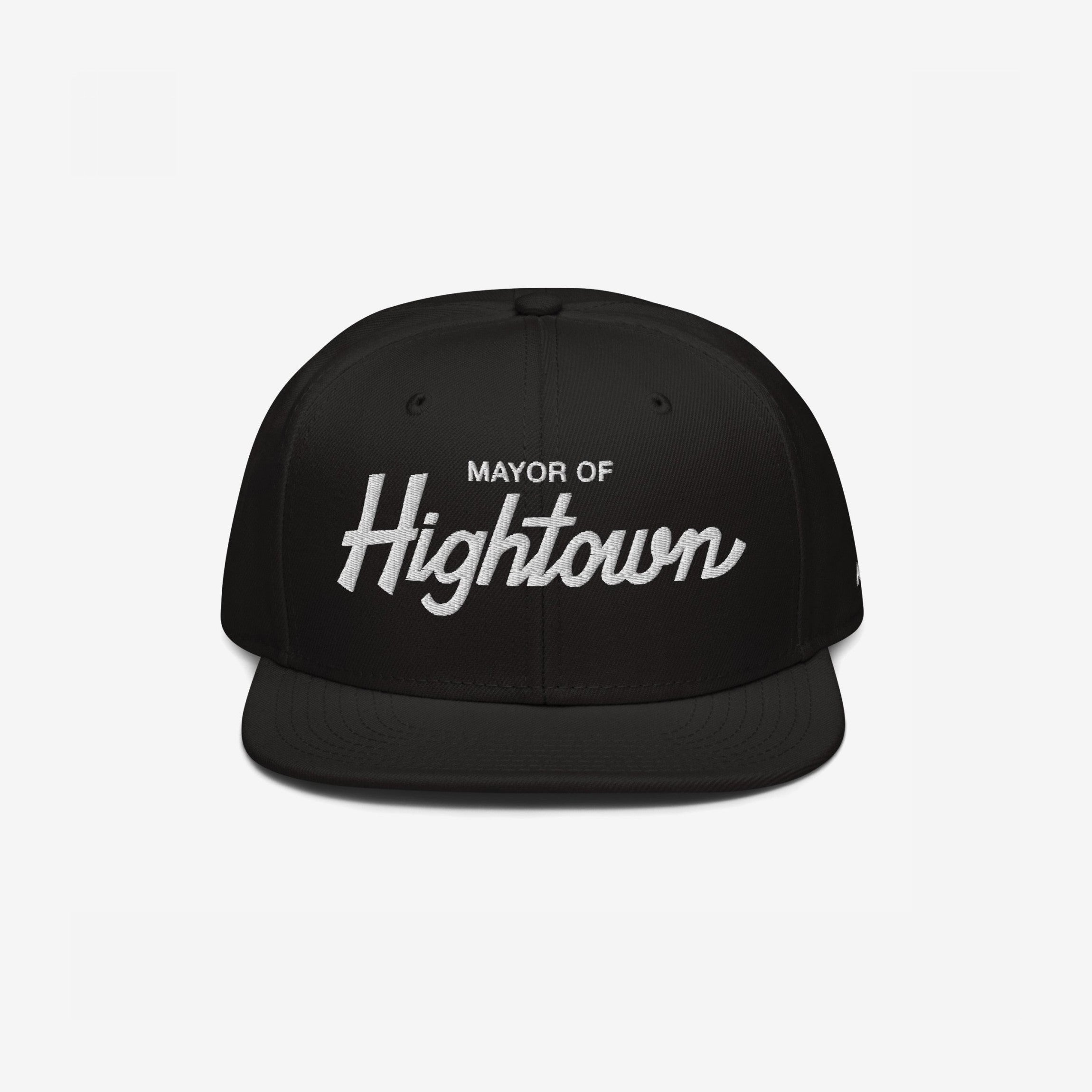Black snapback hat featuring Mayor of Hightown in white embroidery, embodying a playful and bold statement for cannabis culture enthusiasts, reflecting an inclusive and high-spirited ethos.
