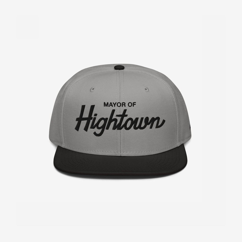 Two-tone flat-bill snapback cap with Mayor of Hightown embroidered on the front, embodying a playful and rebellious spirit ideal for cannabis enthusiasts and lovers of elevated humor.