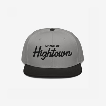 Two-tone flat-bill snapback cap with Mayor of Hightown embroidered on the front, embodying a playful and rebellious spirit ideal for cannabis enthusiasts and lovers of elevated humor.
