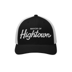 Trucker-style baseball cap with white mesh back, featuring MAYOR OF Hightown embroidered on the black front, reflecting a pla