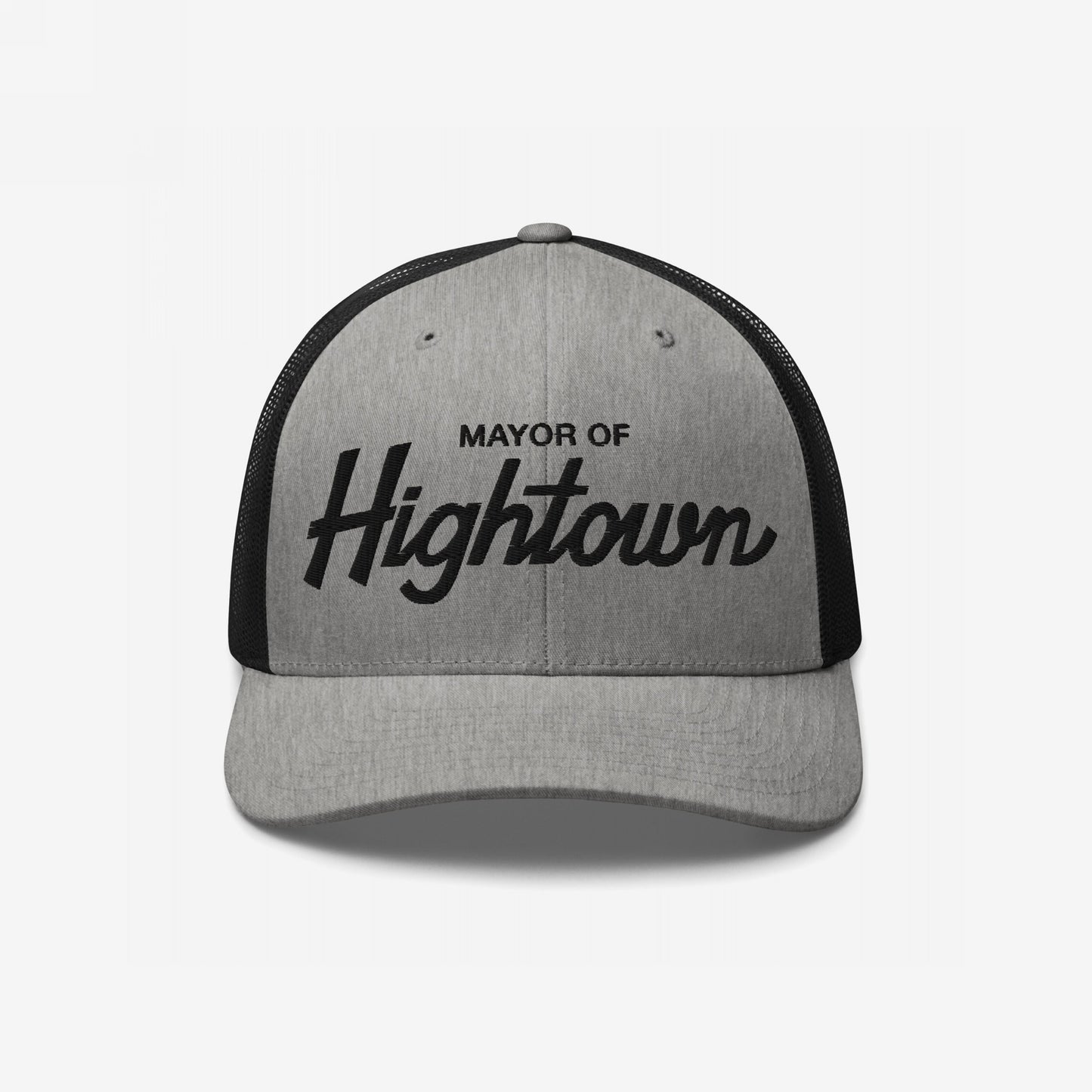 Two-tone trucker-style Mayor of Hightown Hat with light gray front and black mesh back, featuring bold embroidered lettering, embodying a playful, cannabis-inspired vibe for laid-back enthusiasts.