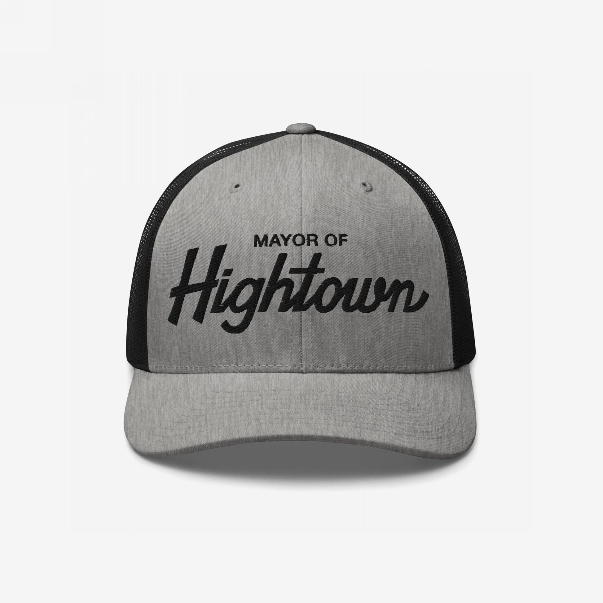 Two-tone trucker-style Mayor of Hightown Hat with light gray front and black mesh back, featuring bold embroidered lettering, embodying a playful, cannabis-inspired vibe for laid-back enthusiasts.