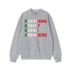 Heather-gray crewneck sweatshirt with Mexicans Aren’t Going Anywhere slogan in Mexican flag colors, symbolizing defiance an