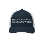 Navy-blue and white mesh-back trucker hat with Mexicans Aren’t Going Anywhere embroidered, symbolizing resistance and pride