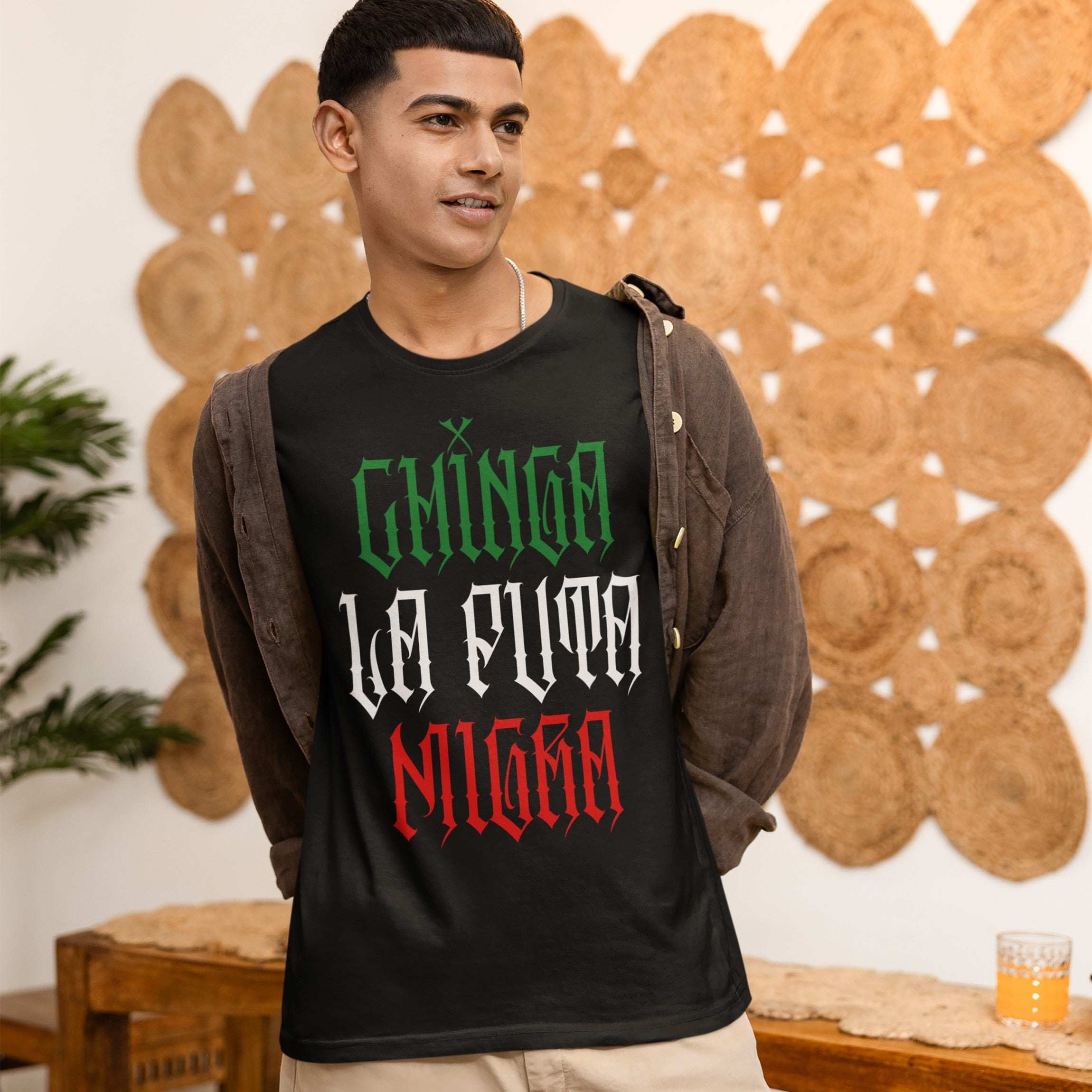 Young man wearing the Chinga La Migra Mexico T-shirt, featuring bold lettering. The shirt represents a stance against anti-immigrant systems, emphasizing cultural pride and resistance.