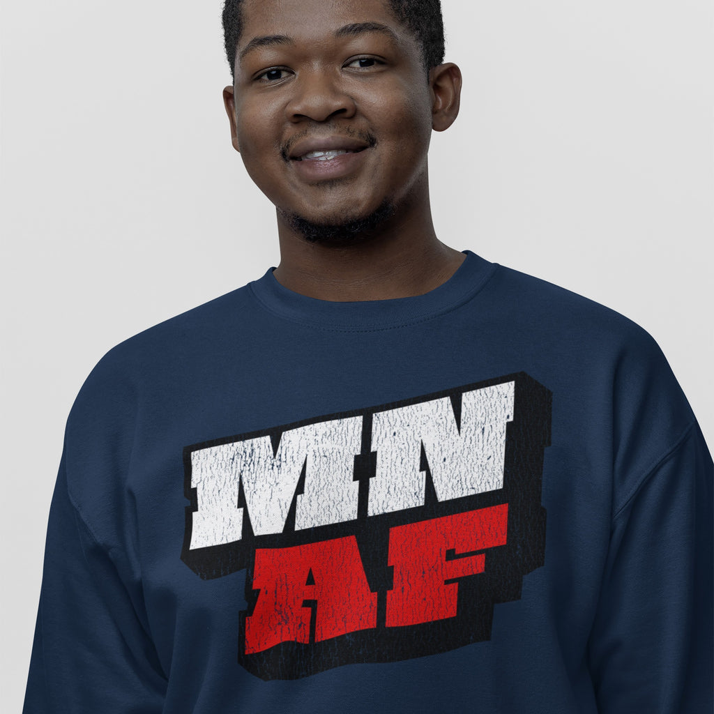 Smiling man in a navy-blue sweatshirt featuring MN AF in distressed white and textured red block print, representing Minnesota As Fuck Anti-Fascist Hoodie & Sweatshirt, symbolizing equality and anti-fascism.