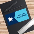 Minnesota Flag No Kings Sticker & Magnet on a workspace mat, featuring a seven-pointed star and bold text NO KINGS NO MASTERS, accompanied by stylus pens and a stainless-steel ruler.