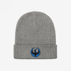 The Minnesota Rebel Alliance Hat features a grey rib-knit beanie with a folded cuff, showcasing an embroidered patch of a stylized black bird, embodying the spirit of protest and equality.