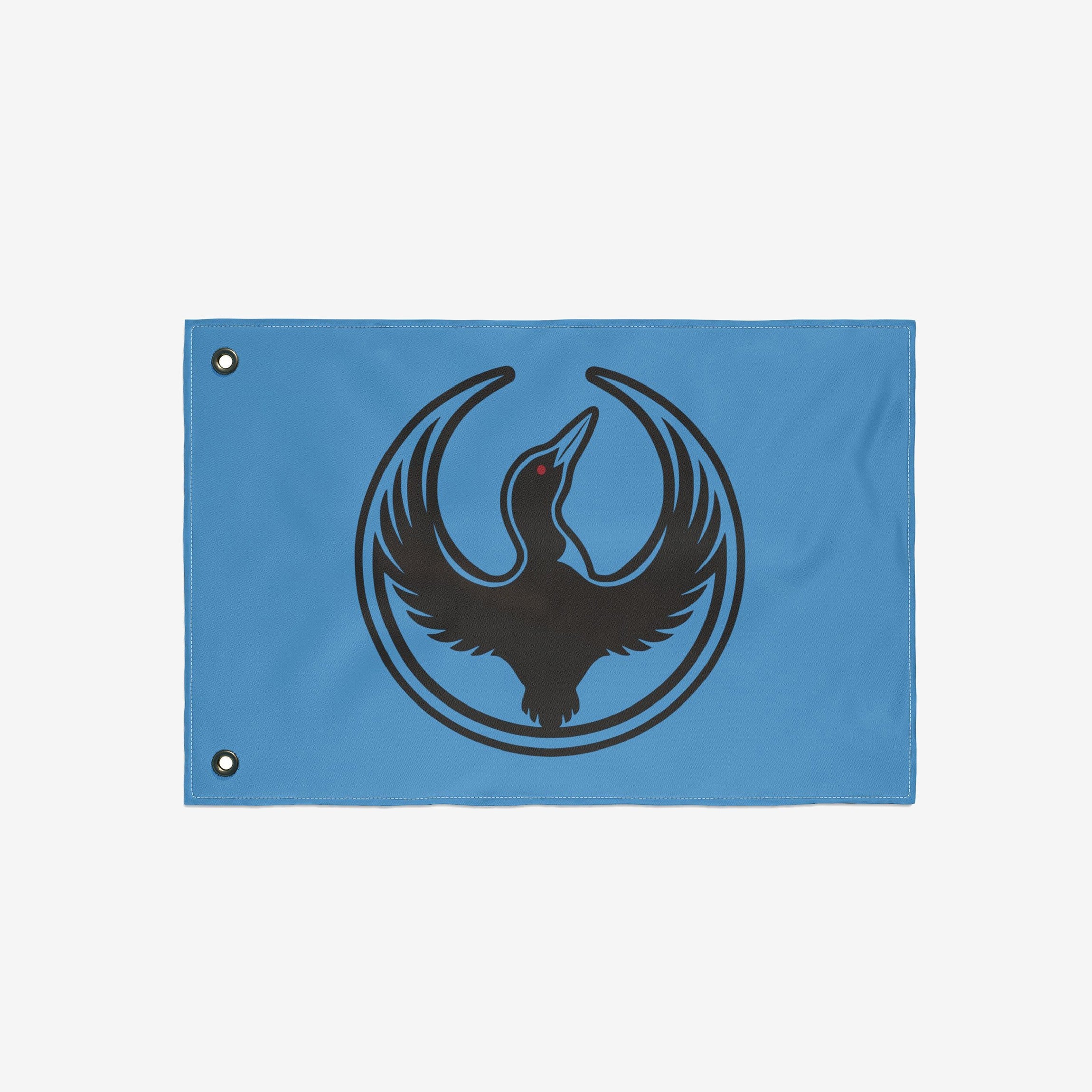 Minnesota Rebel Alliance Flag featuring a black loon silhouette with a red eye, encircled by its wings, on a sky-blue background with metal grommets for hanging.