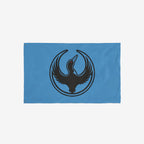 Minnesota Rebel Alliance Flag featuring a bold black loon emblem with outstretched wings on a light-blue background. The design symbolizes resistance and equality, aligning with the store's advocacy for immigrant rights.