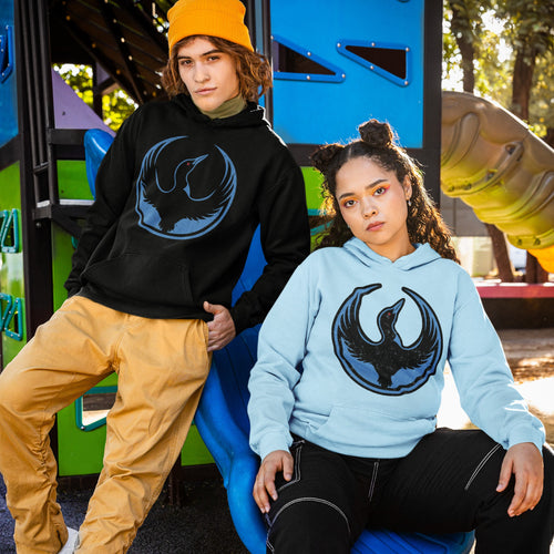 Two young adults on a playground slide wear Minnesota Rebel Alliance hoodies, showcasing the bold loon emblem, symbolizing support for immigrant rights and equality.