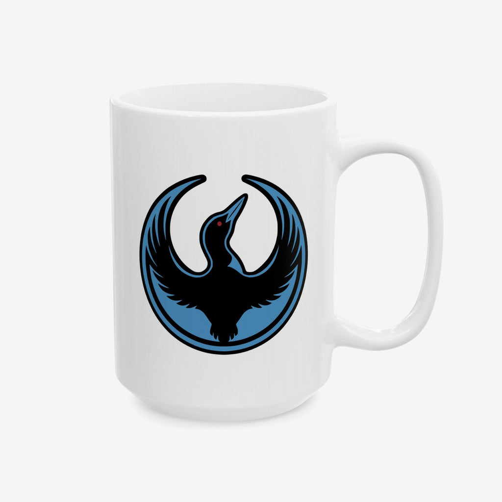 Minnesota Rebel Alliance Mug featuring a black loon with raised wings and red eye inside a blue circle, symbolizing resistance and solidarity, printed on a white ceramic mug. Available in 11 oz. and 15 oz.