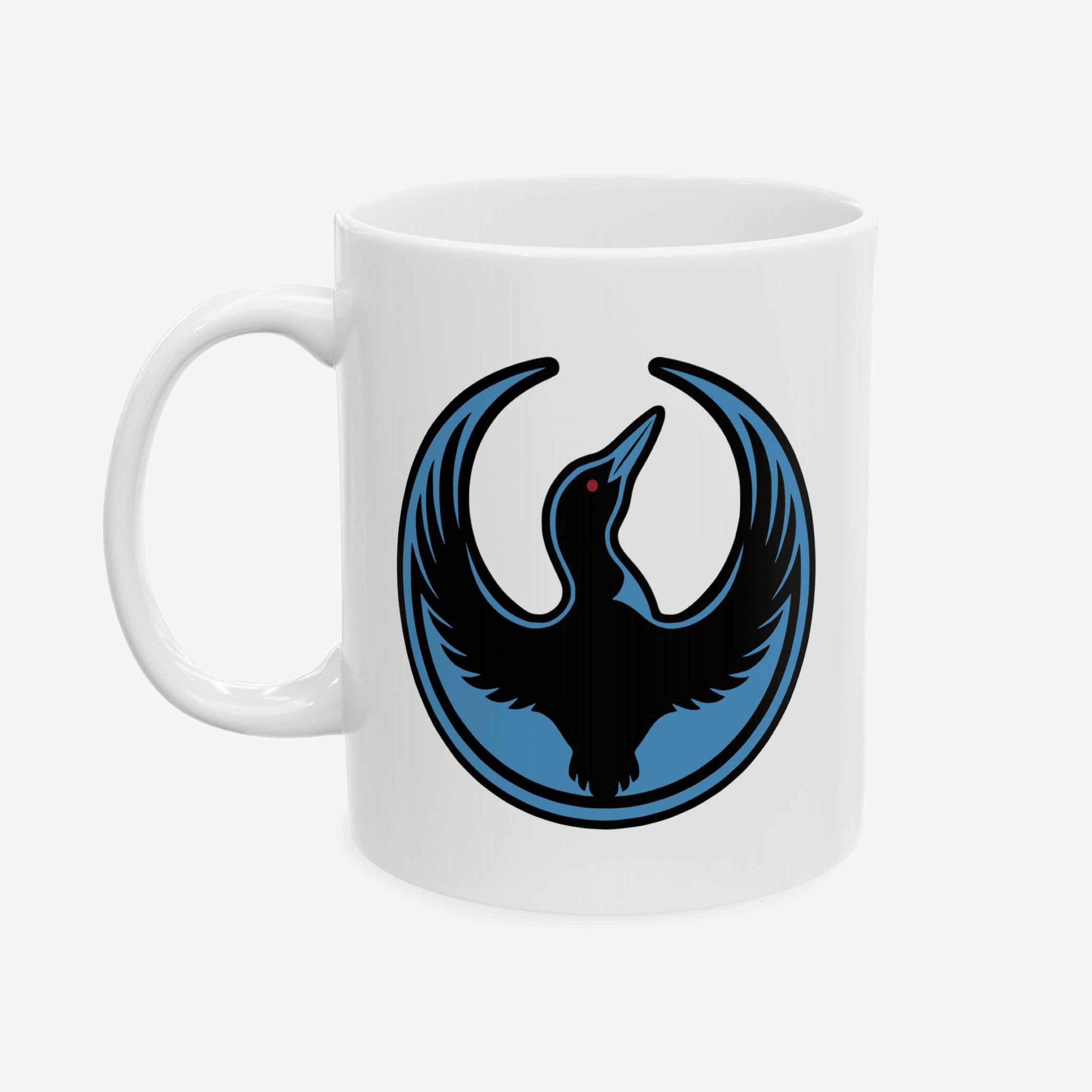 Minnesota Rebel Alliance Mug featuring a stylized bird silhouette with blue accents and red eye, symbolizing resistance and unity, printed on a white ceramic mug. Available in 11 oz. and 15 oz.