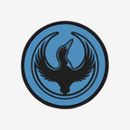 Minnesota Rebel Alliance Patch featuring a stylized black loon with a red eye on a light-blue background, encircled by thin black semicircles, symbolizing resistance and equality.